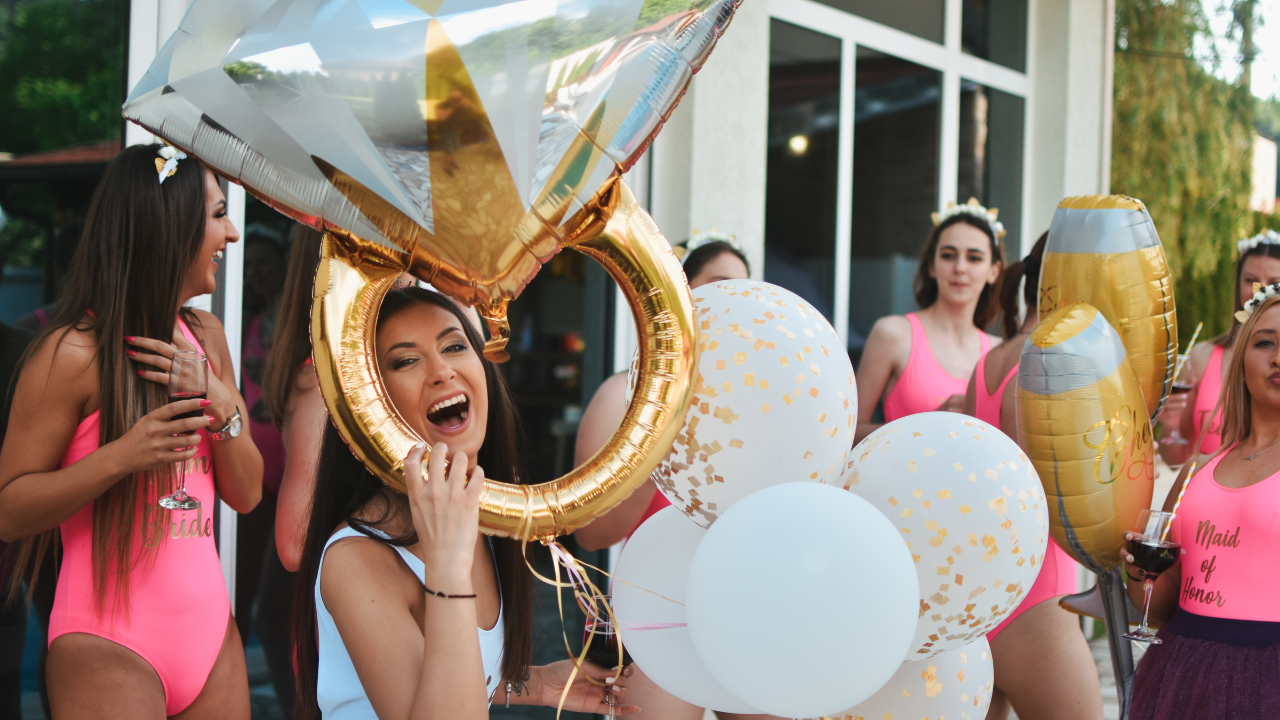 Women celebrating a bachelorette party in Nice French Riviera with balloons and champagne