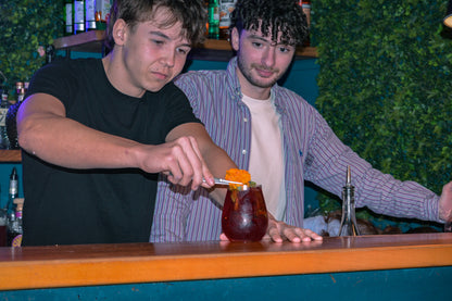 Cocktail workshop in Nice Old Town with bartender preparing a craft drink during a mixology class in a local bar.