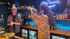 Cocktail workshop in Nice Old Town with participant shaking a drink during an interactive mixology class in a local bar.