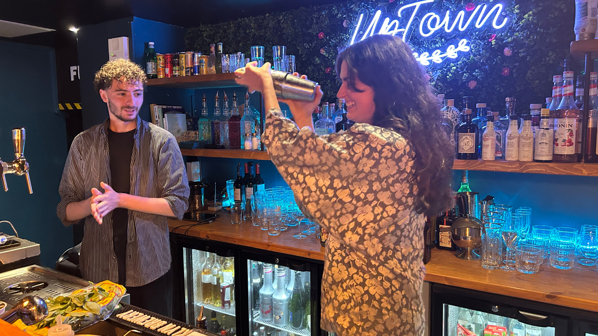 Cocktail workshop in Nice Old Town with participant shaking a drink during an interactive mixology class in a local bar.