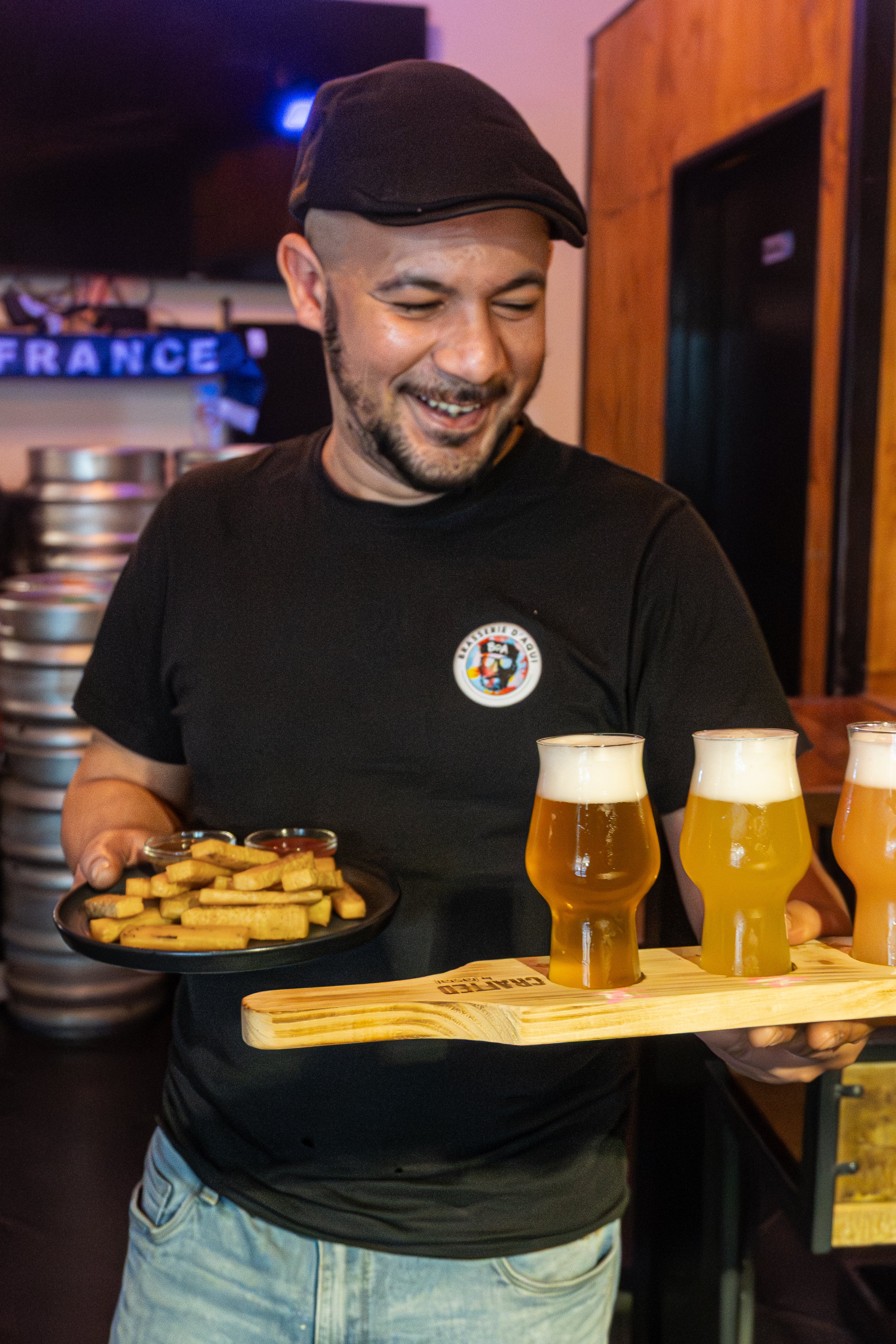 Bartender serving craft beer flight in Nice France local brewery beer tasting experience French Riviera nightlife bar drinks and snacks tasting experience