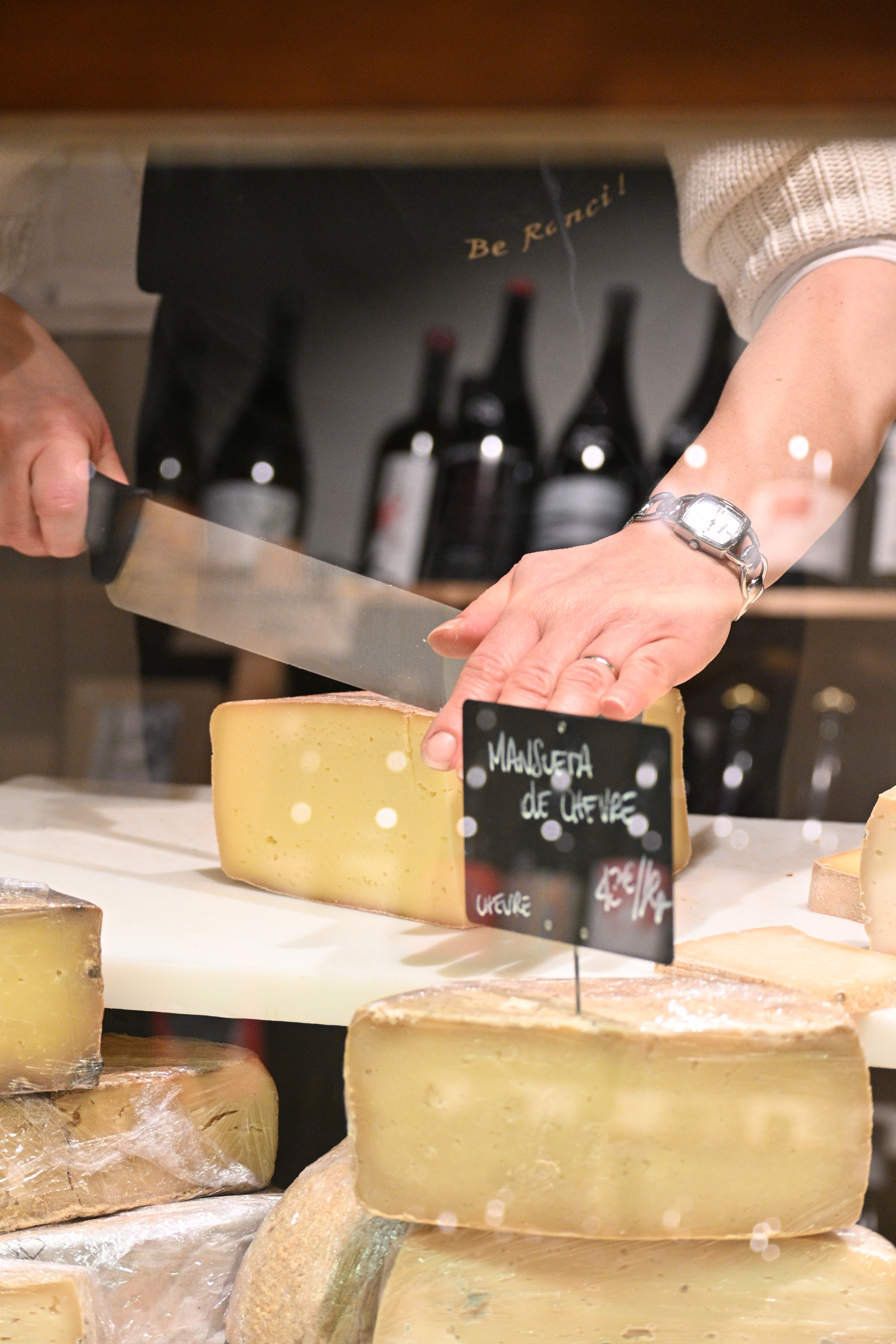 Traditional French cheese cutting during a cheese tasting experience in Nice