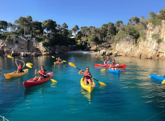 Kayak tour in Cap d’Antibes exploring secret coves on the French Riviera with group paddling in turquoise Mediterranean water.