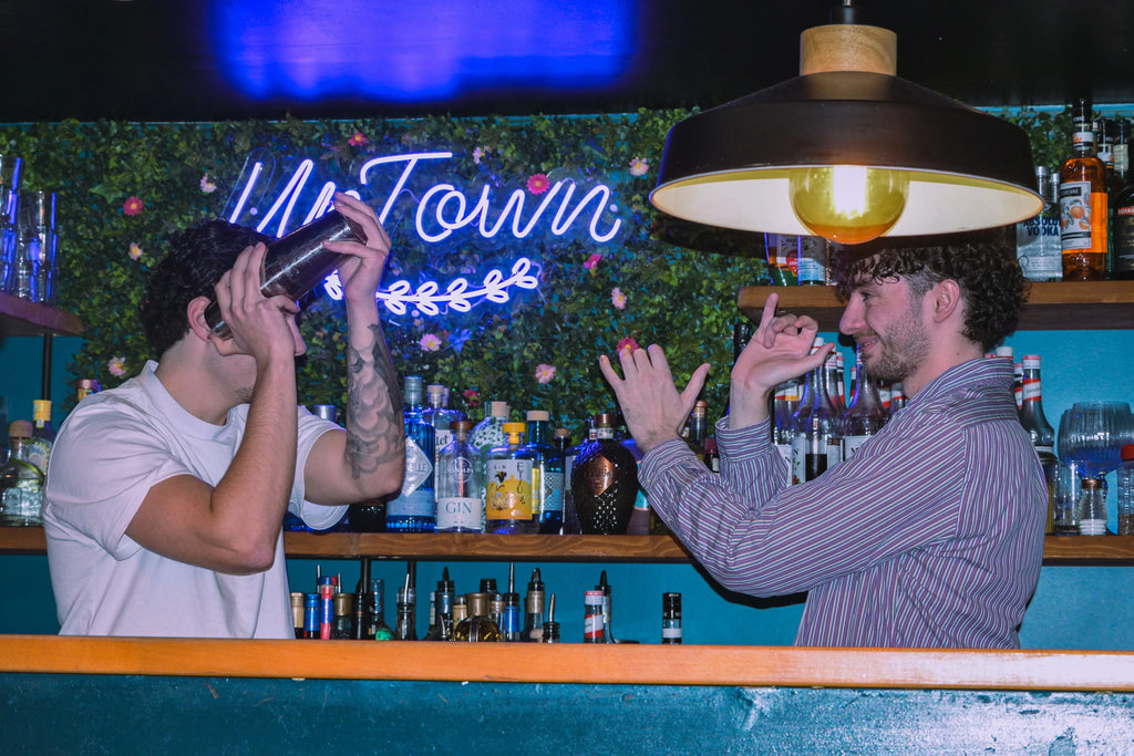 Mixology class in Nice Old Town with bartenders shaking cocktails during an interactive cocktail workshop in a local bar.