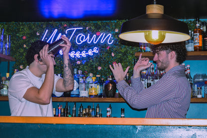 Mixology class in Nice Old Town with bartenders shaking cocktails during an interactive cocktail workshop in a local bar.