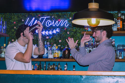 Mixology class in Nice Old Town with bartenders shaking cocktails during an interactive cocktail workshop in a local bar.