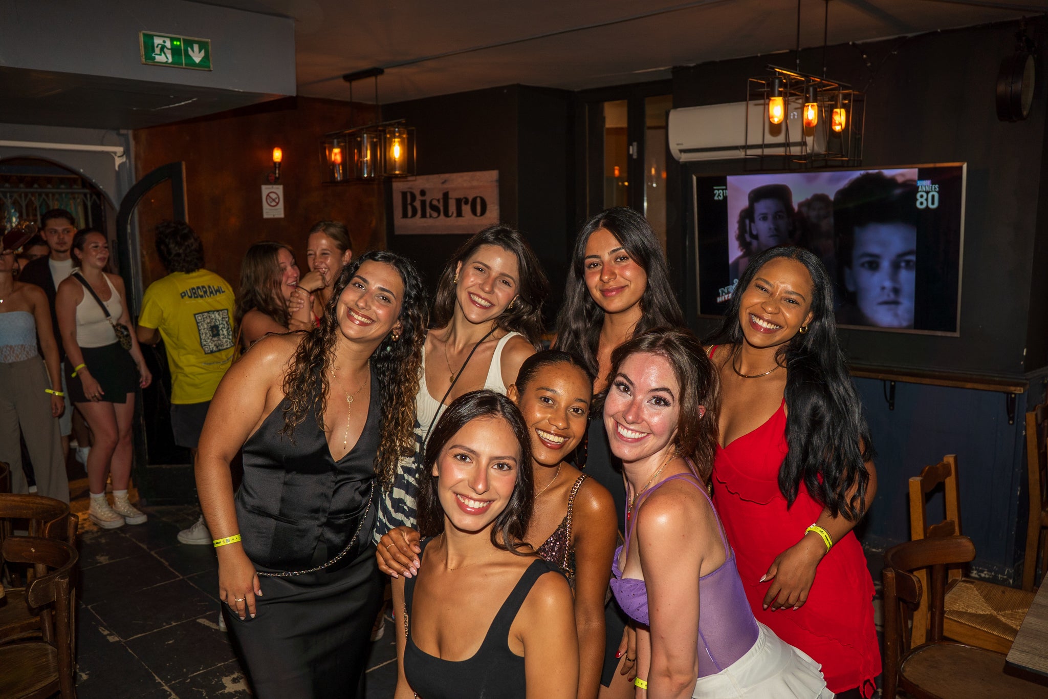 Pub crawl in Nice Old Town with group of friends enjoying nightlife during a guided bar tour experience on the French Riviera.