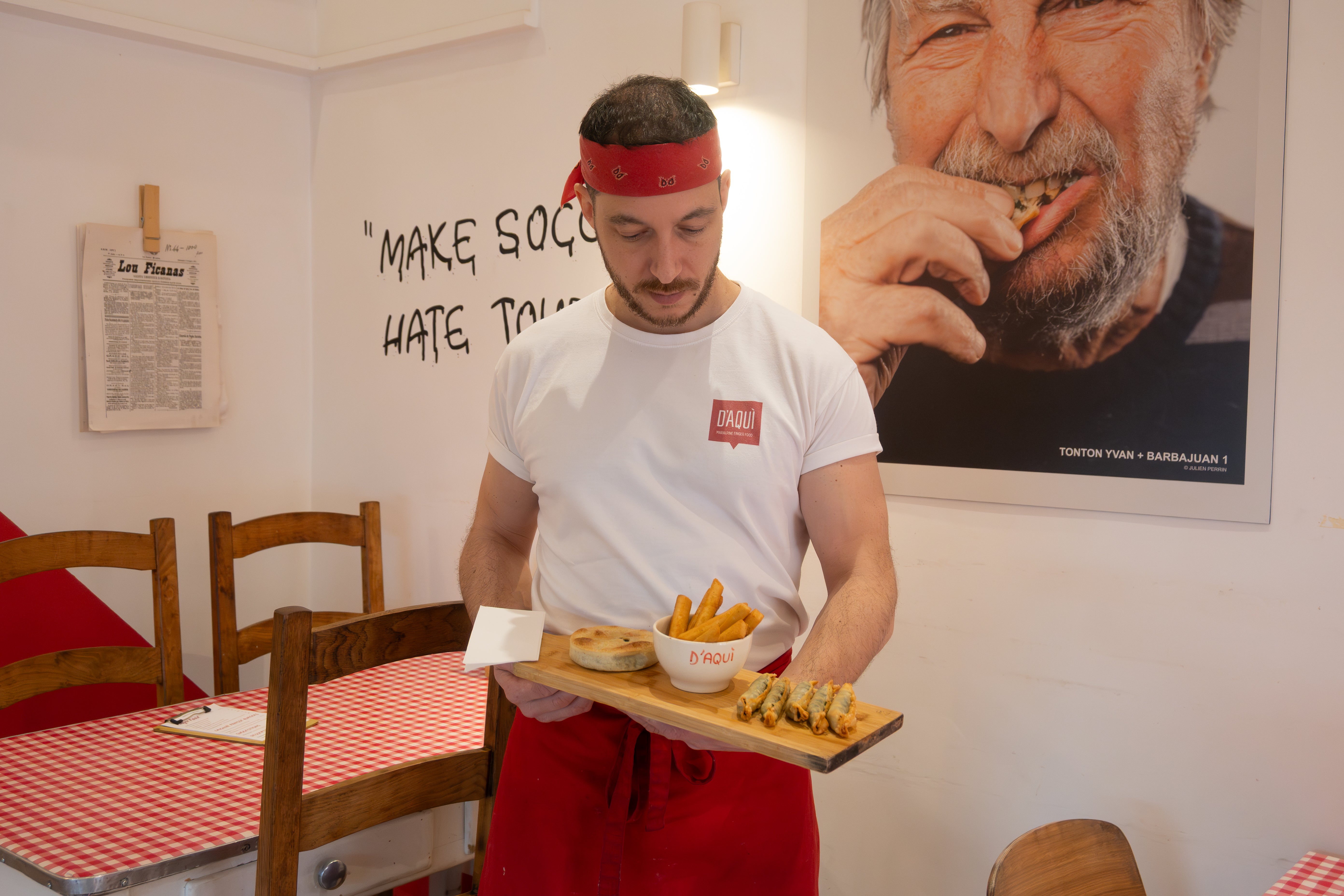 Restaurant staff serving local street food in Nice France French Riviera casual dining traditional snacks Mediterranean cuisine food experience Nice restaurant interior